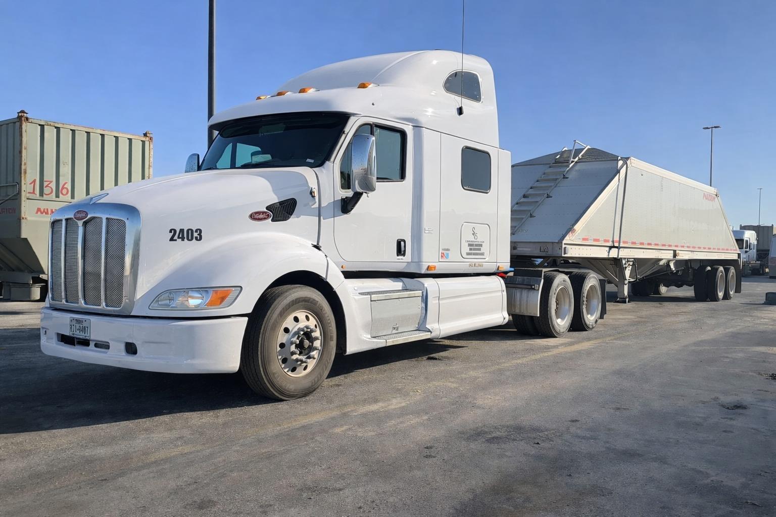White Peterbilt 2403 tractor on a Permian Basin frac sand haul